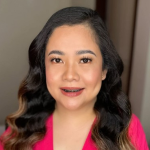 Portrait of Cindy, a Filipino USRN nurse, smiling with hope and determination.