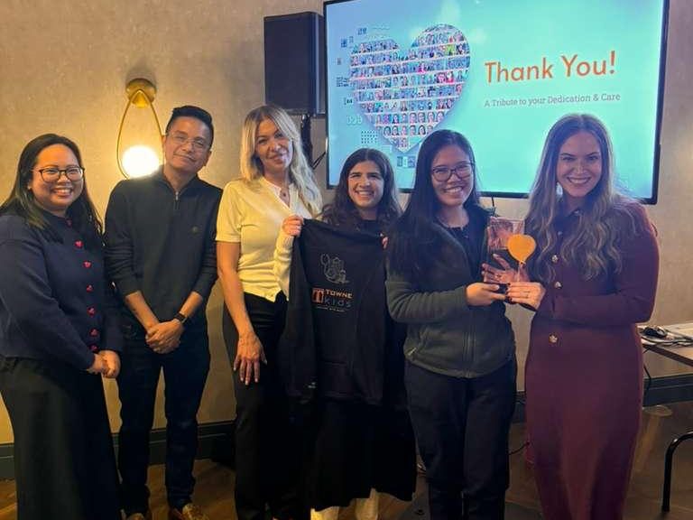 Filipino nurses and Towne Kids staff holding awards during a recognition event in Lakewood, New Jersey.