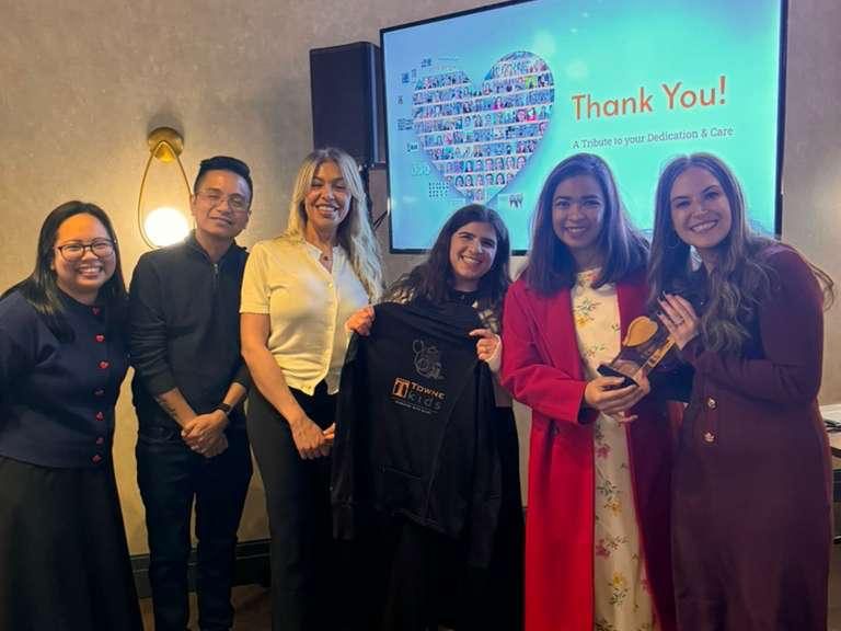 Filipino nurses and Towne Kids team gathered for a group photo during a celebration of nursing milestones.