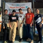 Towne Kids Toy Drive volunteers in Cebu standing in front of Hope for Cebu banner