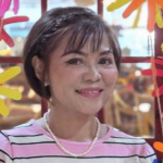 Portrait of Filipino nurse Myla Joy, USRN, smiling confidently.