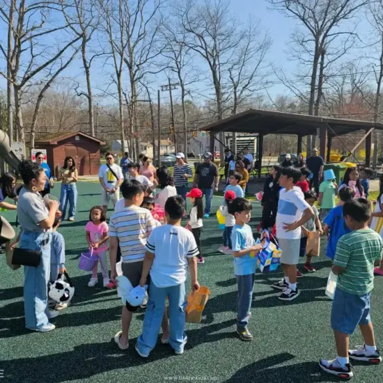 Families and children gathering at a playground during Towne Kids Easter event celebrating nurses and their families