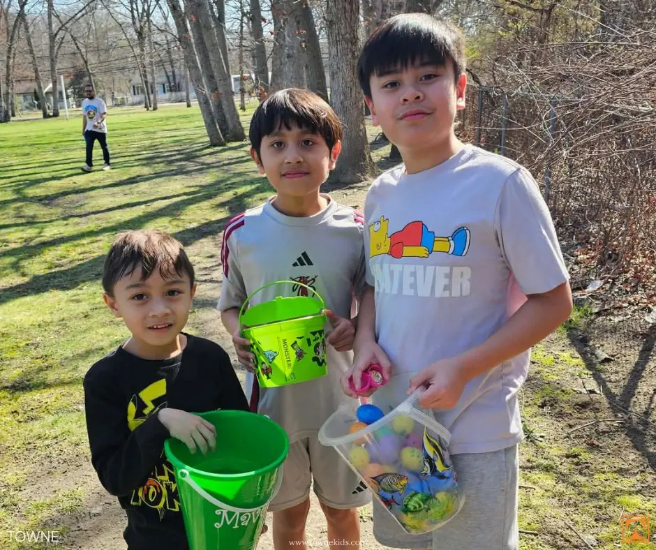 Children holding colorful Easter buckets filled with eggs at Towne Kids family Easter event with nurses